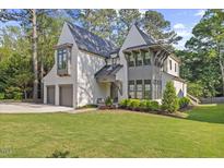 Stunning two-story home featuring a landscaped front yard and a convenient two-car garage at 1304 Ivy Ln, Raleigh, NC 27609