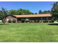 Brick ranch house with a large front yard at 1521 Nc-87, Elon, NC 27244