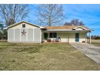 Charming single-story home featuring a covered front porch, well-maintained lawn, and quaint curb appeal at 1587 Crockers Nub Rd, Middlesex, NC 27557
