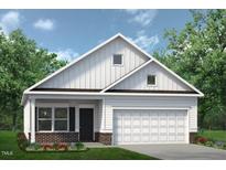 White farmhouse-style home with brick accents and a two-car garage at 196 Deodora Ln, Cameron, NC 28326