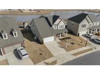Two-story house with a spacious yard and lake view in a quiet neighborhood at 2120 Blue Iris Way, Zebulon, NC 27597