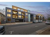 Modern apartment building featuring a secure parking garage and inviting balcony spaces at 29 Enterprise St # 107, Raleigh, NC 27607
