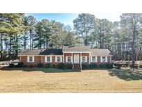 Brick ranch house with a spacious yard and mature trees at 3129 Barwell Rd Rd, Raleigh, NC 27610