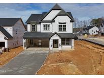 Two-story home with white siding, gray trim, and a two-car garage at 3284 Roundly Rd # 16, New Hill, NC 27562