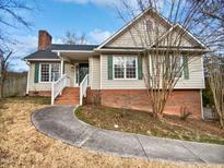 Brick and siding ranch home with a landscaped yard and walkway at 3321 Beech Bluff Ln, Raleigh, NC 27616