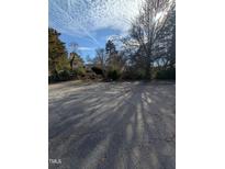 Spacious parking lot with mature trees surrounding the property at 4053 Little Creek Church Rd, Clayton, NC 27520