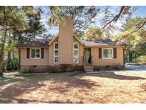 Charming single-Gathering home featuring a chimney, multiple windows, and a well-maintained lawn at 6 Winchester Ct, Durham, NC 27707