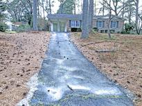 Ranch house with long driveway, surrounded by trees at 7317 Bentley Wood Ln, Raleigh, NC 27616