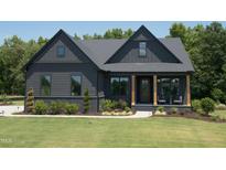 Craftsman style home with dark siding, light trim, and a covered porch at 82 Byrd Ln, Pittsboro, NC 27312