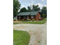 Charming single-story home with well-maintained landscaping and a gravel driveway at 1018 Lakeview Dr, Cedar Grove, NC 27231