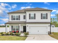 Two-story home featuring a two-car garage, front porch, white siding and black shutters at 108 Bonnie Girl Ct, Lillington, NC 27546