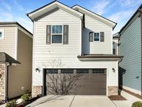 Two-story house with neutral siding, brown garage door, and landscaping at 1134 Chestnut Bluff, Apex, NC 27502