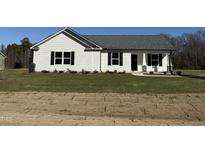 White house with gray roof, landscaping, and stone accents at 148 Phil Jack Rd, Dunn, NC 28334