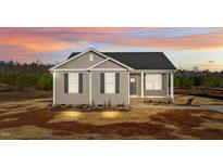 Charming single-story home with a cozy front porch and beautiful sunset sky at 150 Brookhaven Dr, Spring Hope, NC 27882