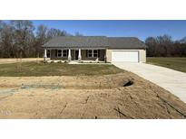 Ranch style house with gray roof, attached garage, and landscaping at 186 Phil Jack Rd, Dunn, NC 28334