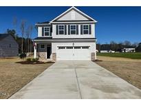 Charming two-story home with a well-manicured lawn and a spacious two-car garage at 200 Wild Turkey Way Way, Lillington, NC 27546