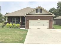 Brick ranch home with attached garage and manicured lawn at 2001 Bunnfield Dr, Zebulon, NC 27597