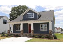 Two-story craftsman home with gray siding, red door, and stone accents at 211 W Harnett St, Dunn, NC 28334