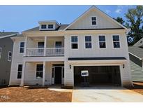 New construction, two-story home boasts a welcoming front porch and attached two-car garage at 227 Augusta Pond Way # 159, Raleigh, NC 27603