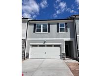 New construction two-story home with a two-car garage and light grey siding at 7113 Hubner Pl # 20, Cary, NC 27519