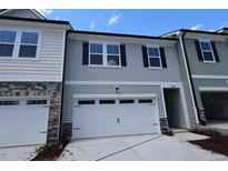 View of the exterior of a two-story home with a white garage door at 7113 Hubner Pl # 20, Cary, NC 27519