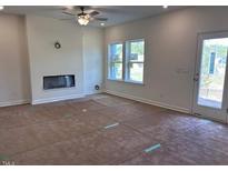 Bright living room with a fireplace and windows letting in plenty of natural light at 7115 Hubner Pl # 21, Cary, NC 27519