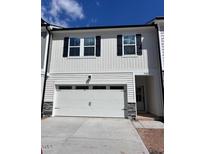 Charming two-story home featuring a two-car garage and classic white siding at 7117 Hubner Pl # 22, Cary, NC 27519