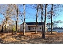 Newly constructed house with gray siding, front porch, and surrounding trees at 170 Squirrel Path Way, Roxboro, NC 27574