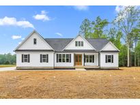 Charming new construction with a white facade, black trim, and an inviting front porch at 250 Ellington Rd, Graham, NC 27253
