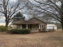 Ranch house with covered porch, detached building, and mature trees at 3077 Christian Light Road Rd, Fuquay Varina, NC 27526