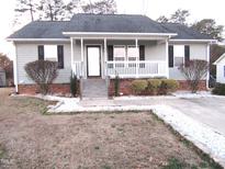 Gray house with white porch and landscaping at 409 James Toney Dr, Elon, NC 27244