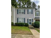 Two-story townhome with neutral siding, green shutters, and a manicured lawn at 4232 Vienna Crest Dr, Raleigh, NC 27613