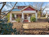 Charming craftsman home with a wrap-around porch and mature trees at 1019 S Main St, Burlington, NC 27215