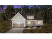 Charming single-Gathering home featuring a two-car garage and a meticulously maintained lawn with mature landscaping at 50 Arbor Dr, Youngsville, NC 27596