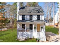 Two-story house with white siding, gray roof, and a front porch at 7709 Highlandview Cir, Raleigh, NC 27613