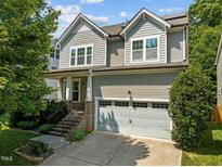 Two-story house with gray siding, brick accents, and a two-car garage at 917 Pirouette Court, Raleigh, NC 27606