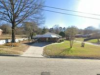 Ranch style home with carport and mature trees at 1100 Hadley Rd, Raleigh, NC 27610