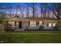 Ranch style home with a spacious lawn and mature trees at 1508 Carroll Heights Rd, Zebulon, NC 27597