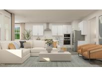 Open floor plan boasts a modern kitchen and spacious living area, perfect for entertaining at 1565 Goldfinch Perch Ln, Knightdale, NC 27545