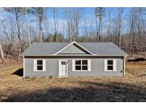 Gray house with white trim, a gray roof and a small front yard at 163 Royal St, Fuquay Varina, NC 27526