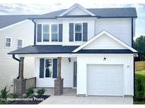 Two-story house featuring a white exterior, gray shutters, and a two-car garage at 346 Maidenhair Pl, Clayton, NC 27520
