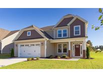Charming two-story home features a manicured lawn and attached two-car garage at 359 Ballast Pt, Clayton, NC 27520
