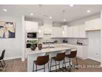 Modern kitchen featuring granite counters, stainless steel appliances, and pendant lighting at 3854 Well Fleet Drive, Fuquay Varina, NC 27526