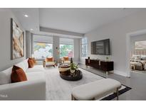 Bright living room features stylish furniture and large windows at 400 W North St # 620, Raleigh, NC 27603