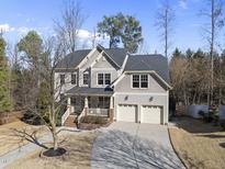 Two-story house with gray siding, brick accents, and a two-car garage at 424 Waverly Hills Dr, Cary, NC 27519