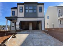 Two-story home with gray and white exterior, two-car garage, and a modern design at 4318 Emeline Ln # 20, Fuquay Varina, NC 27526