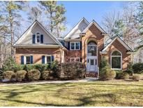 Brick house with a two-car garage and manicured lawn at 5120 Tallwood Dr, Raleigh, NC 27613