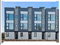 Modern three-story townhouses with gray siding and large windows at 712 E Edenton St # 105, Raleigh, NC 27601