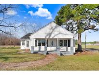 Charming white house with a porch, surrounded by a well-maintained lawn at 8179 Highway 39, Middlesex, NC 27557