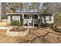 Gray house with white door, landscaping, and stone border at 1304 Rothes Rd, Cary, NC 27511